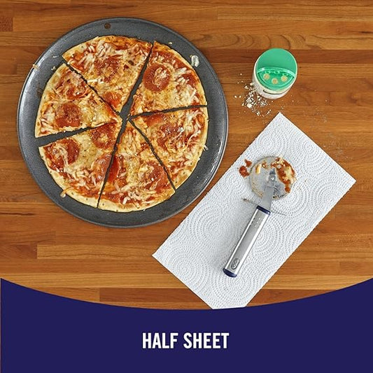 Pizza on a half sheet pan with a pizza cutter and napkin on a wooden table.