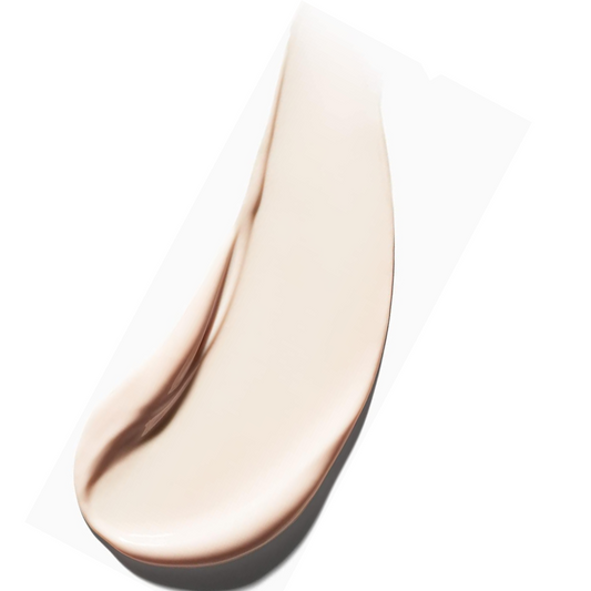 Close-up of a beige cosmetic product smear on a white background