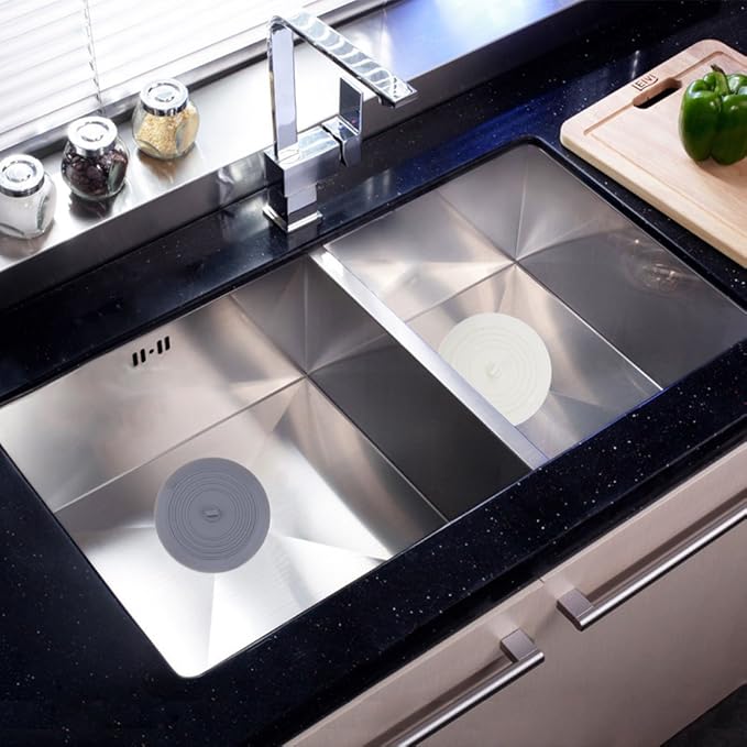 Stainless steel kitchen sink with black countertop