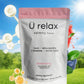 Package of 'Ü relax calming tonic' with natural elements and blue sky background
